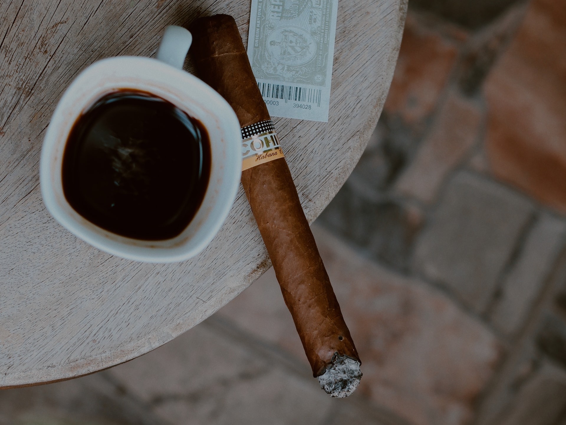 cohiba cigar next to a cup of coffee