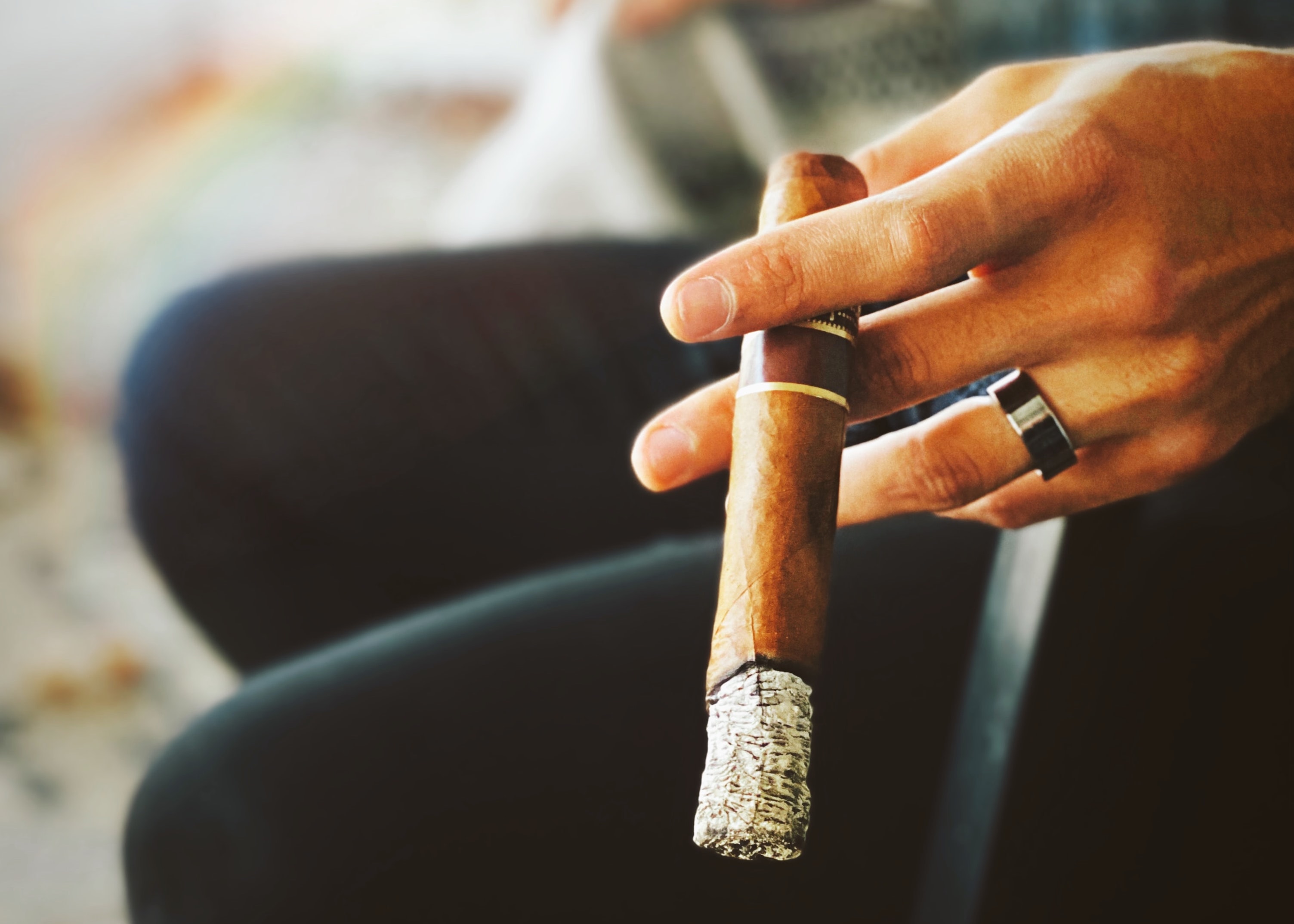 A cigar being held while smoked