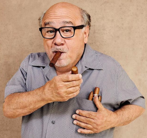 Danny DeVito tucking cigars into his shirt pocket
